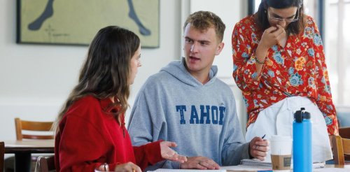 three students in a classroom