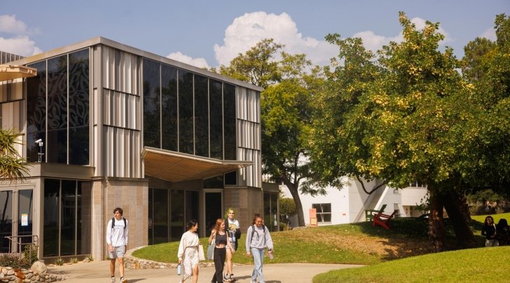 Students walk past the exterior of Benson Auditorium.
