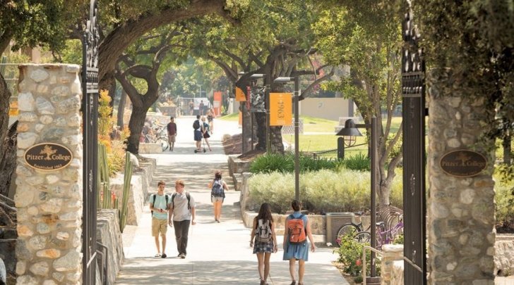 Pitzer College gates with students walking