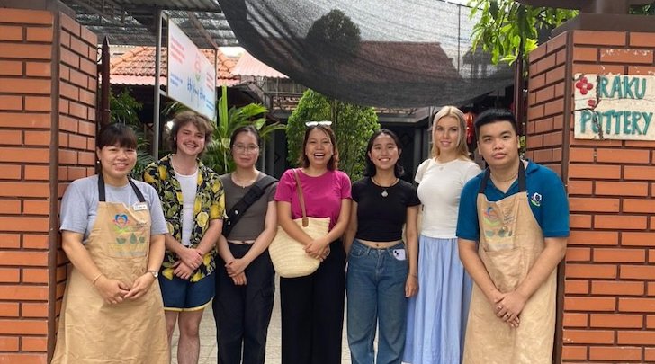 Group in front of sign for Hope Center Vietnam