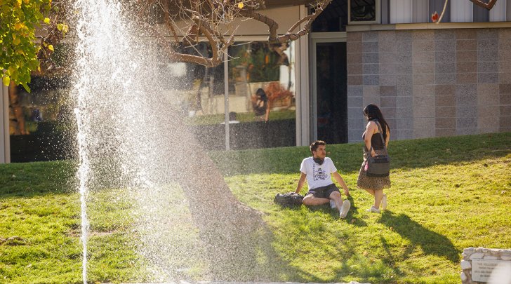 Two students meet outside Benson Auditorium
