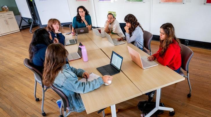 several students and professor sit around a table at CASA Pitzer
