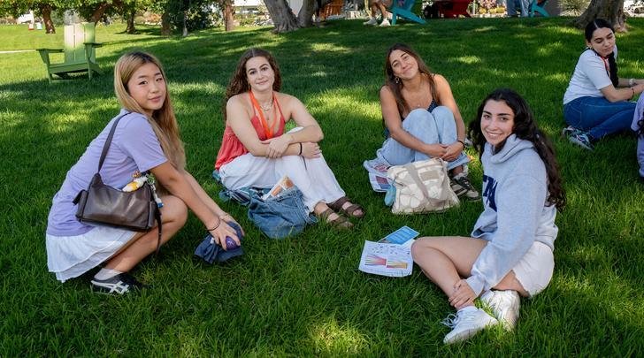 four students sit on the mounds during preview pitzer