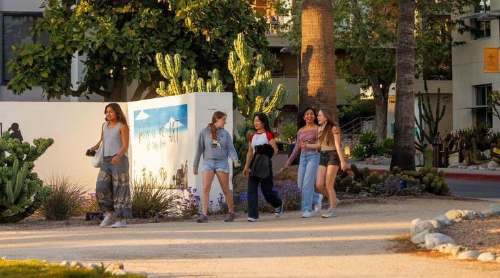 Students walk in Holden Garden outside Mead Hall