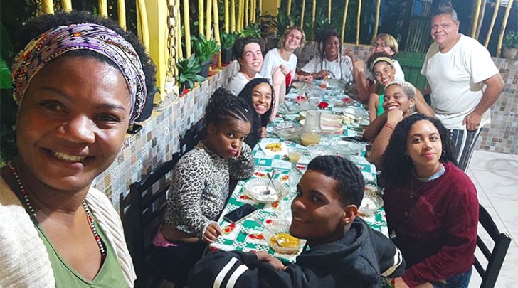 a group of students sit around a table during their time in Brazil