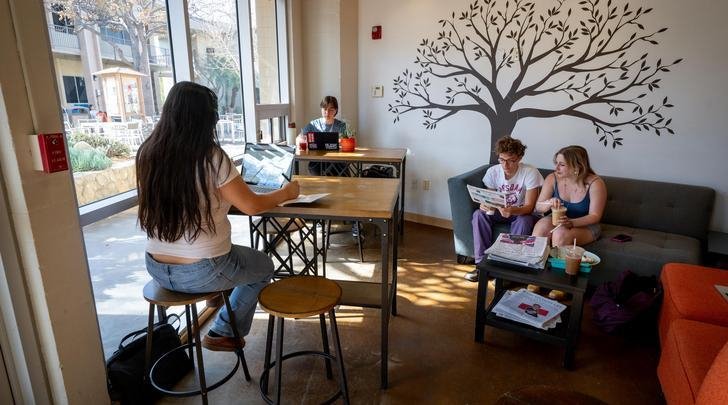 several students sit in the pit stop cafe studying