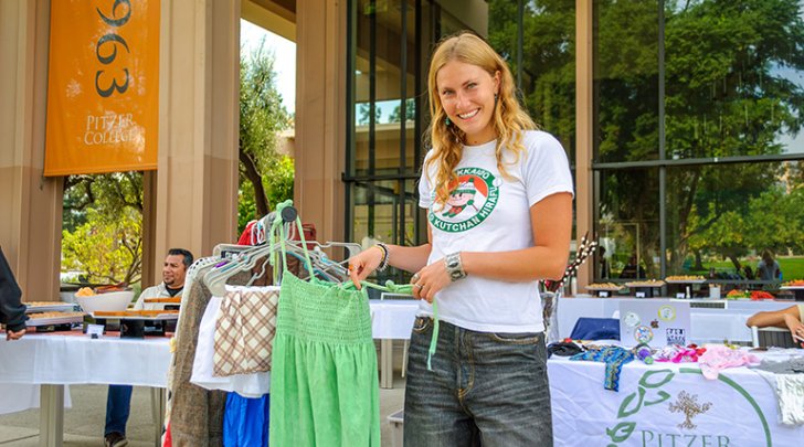 A student sells used clothes at the Pitzer EcoReps Sustainability Fair