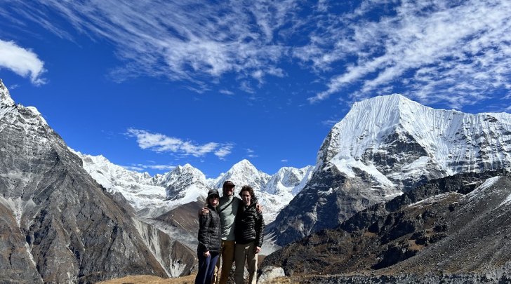 Students standing in front of mountain 