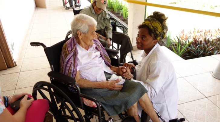 Student talking with women in wheelchair