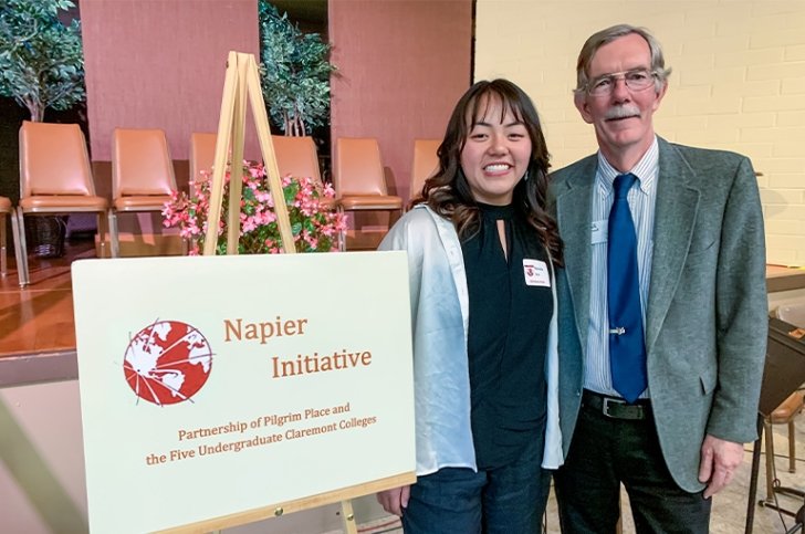 Natasha Yen stands with her mentor Paul Cromwell at the Napier Award ceremony. To their right is a sign that says Napier Initiative.