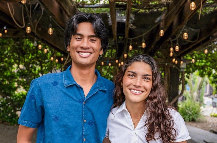 Sammy Basa and Zhane Moledina stand together under the leafy green canopy of Pitzer’s Grove House Outdoor Classroom.