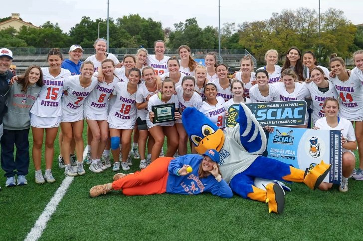 The Pomona Pitzer women’s lacrosse team stands with coaches and Cecil the Sagehen mascot with the SCIAC Tournament Championship banners and placard.