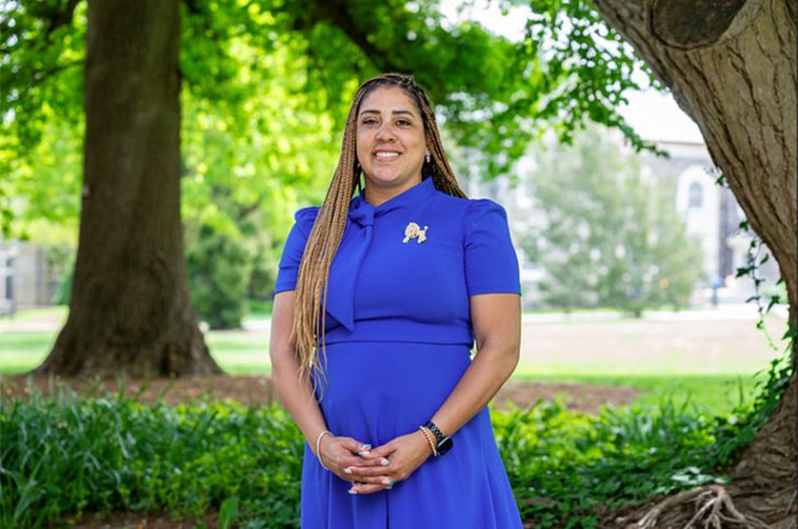 Danielle Lynch stands in front of a field at Pomona College