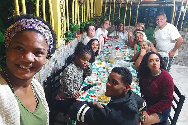 a group of students sit around a table during their time in Brazil