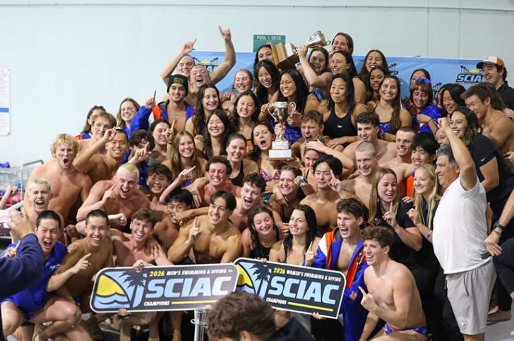 a team cheers and holds up a SCIAC sign