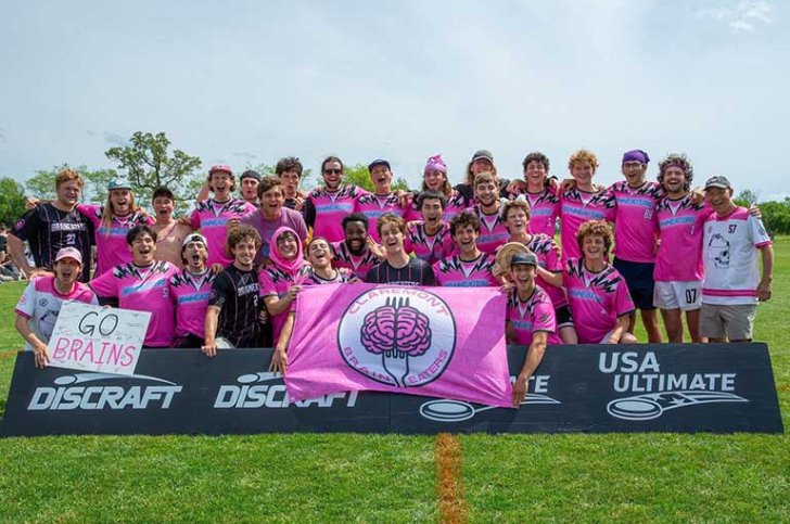 the braineaters team pose with their team banner on a field