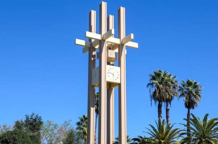 the pitzer clock tower against a blue sky