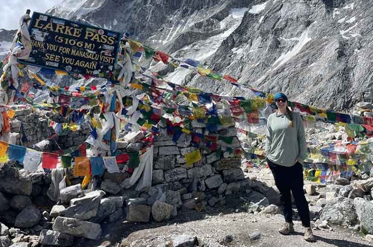 student stands at Larke Pass in Nepal