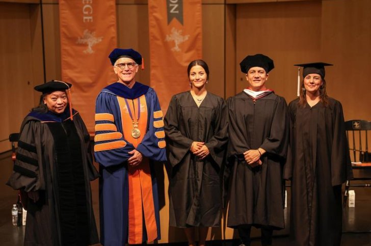 The college president, student senate president and deans standing in front of the podium