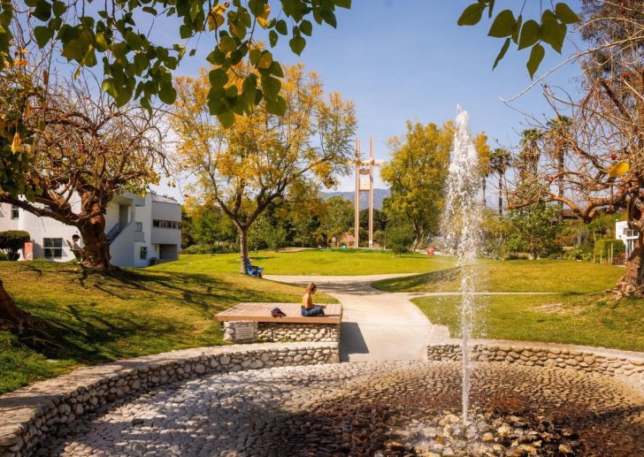 a student sits near the pitzer fountain