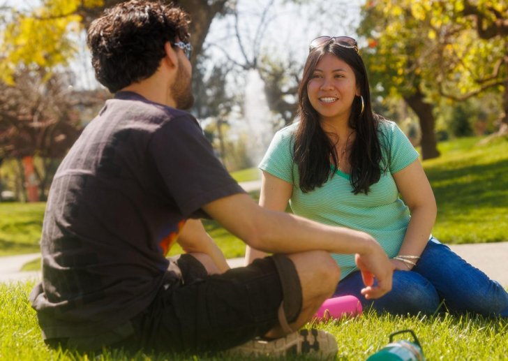 two students talk on the mounds