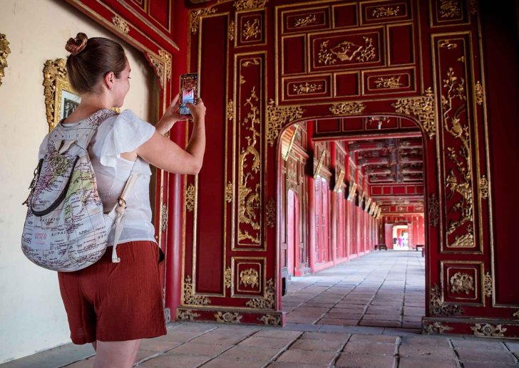a student takes a photo of a hallway at the imperial palace