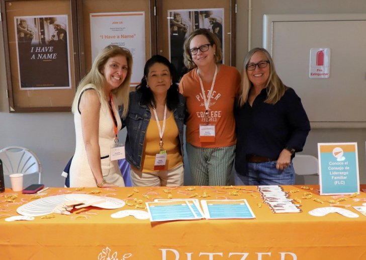 Family Leadership Council members standing at a welcome table.