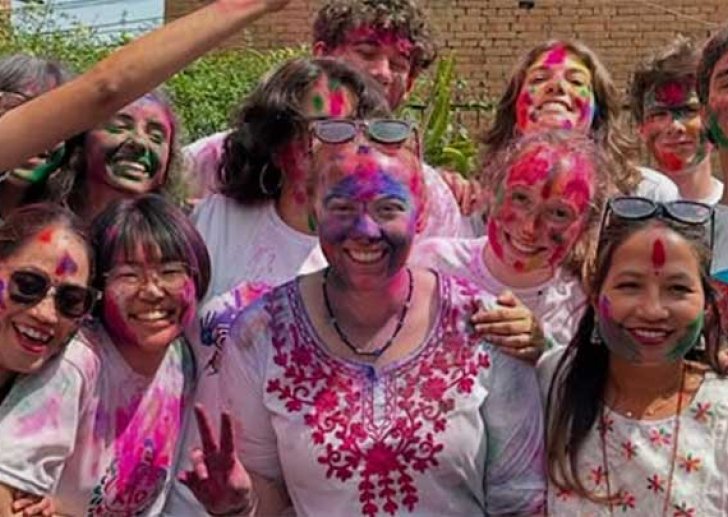student pose with pink powder on their faces