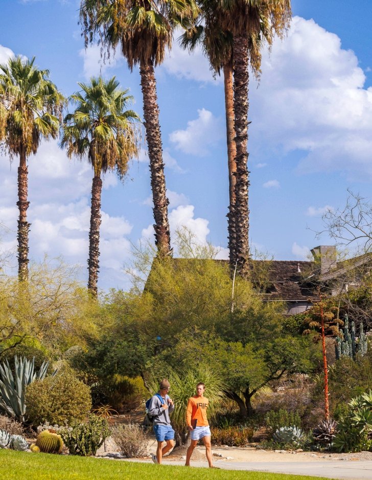 Students walk to class in front of the Grove House