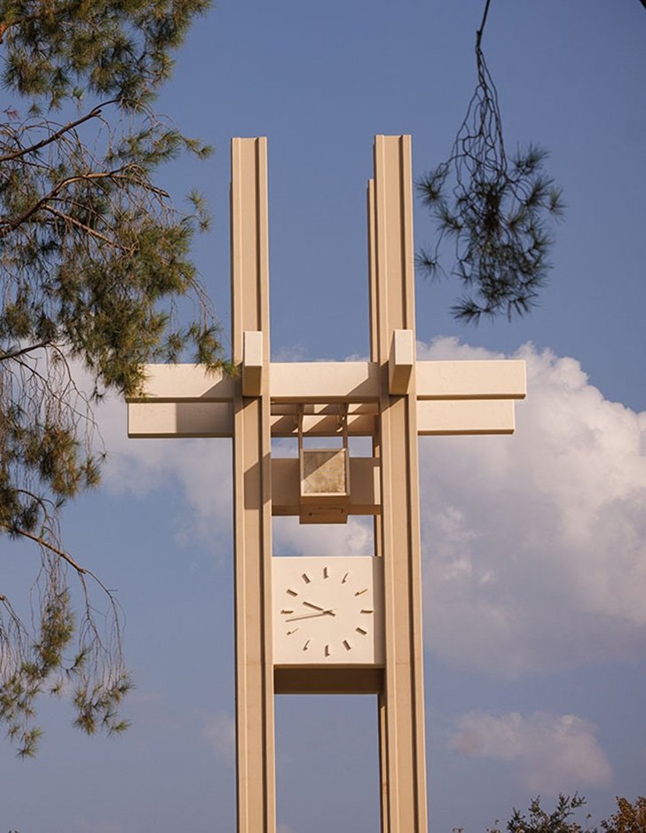 pitzer clock tower against a blue sky