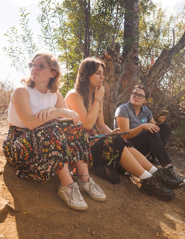 three students sit in the bernard field station