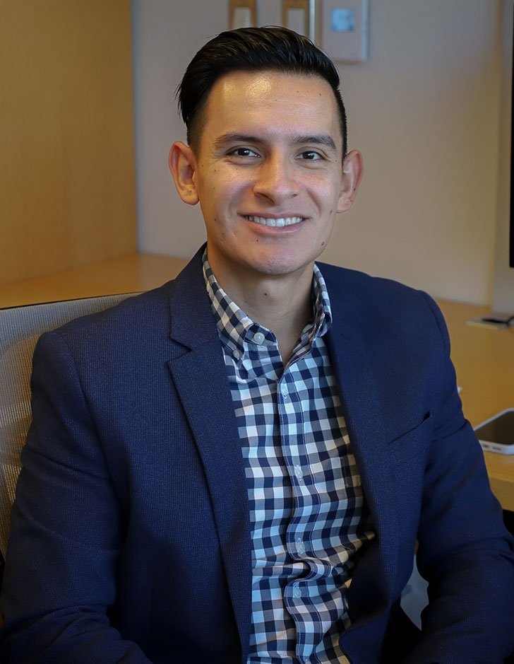 portrait of cesar vargas nunex sitting at a desk in a office