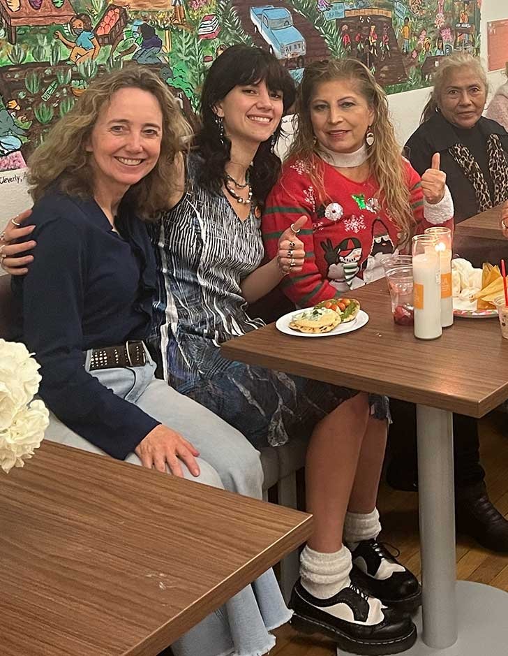 andrea robinowitz sits at a table with three other women at Casa Pitzer