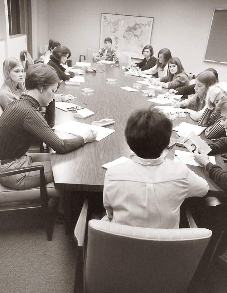 several women sit at a long table during a Pitzer class in 1968