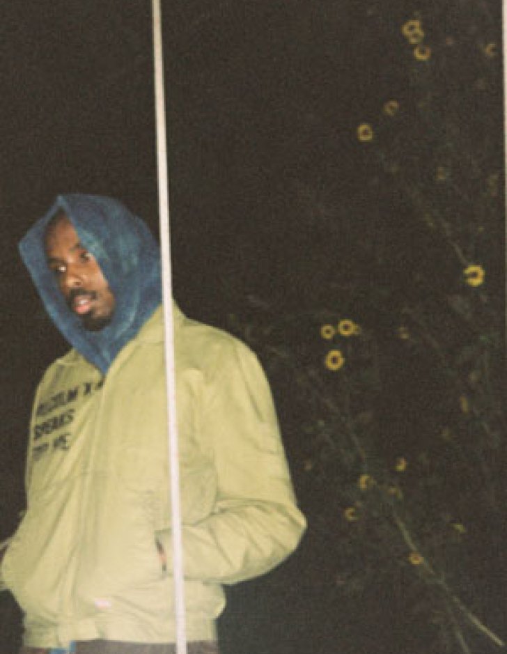 Marvin James wears a pale yellow jacket and a blue hood.