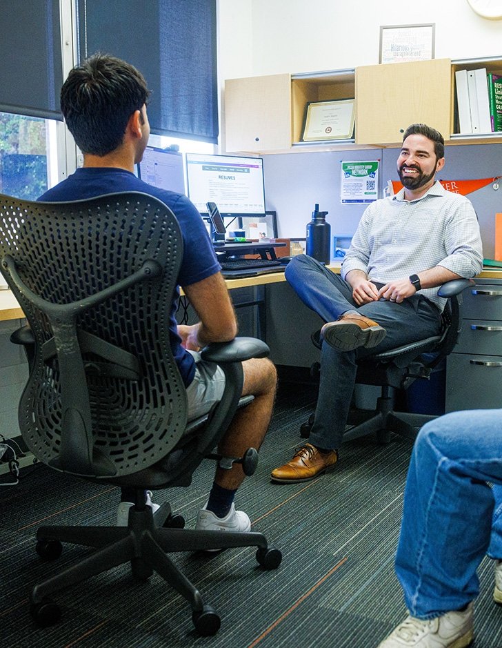 Career Services director Andre Argaez talks to a student