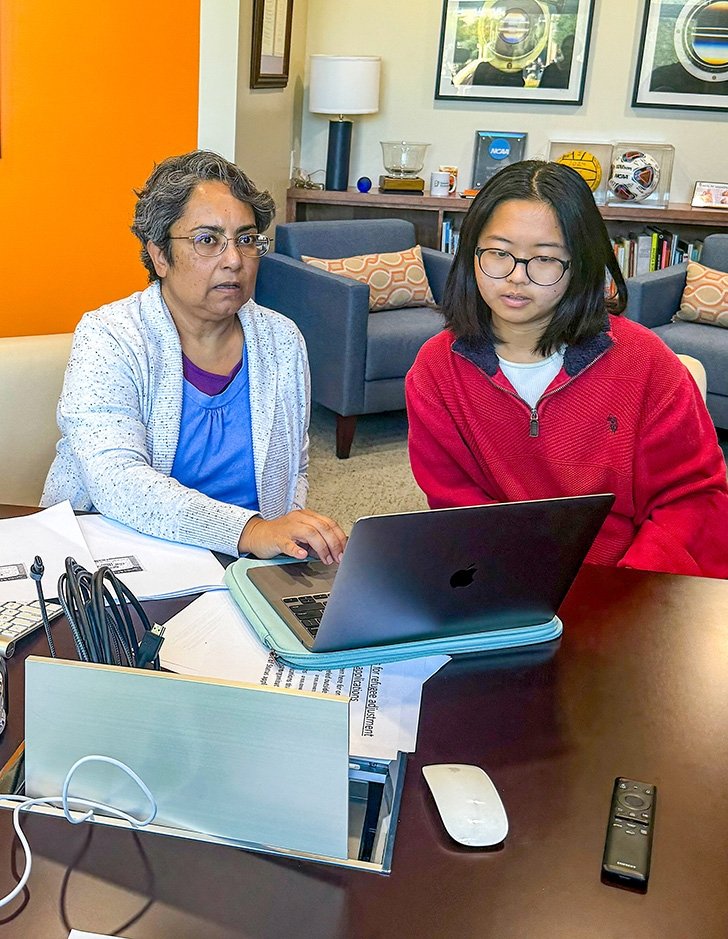 Prof. Sumangala Bhattacharya works with a student volunteer