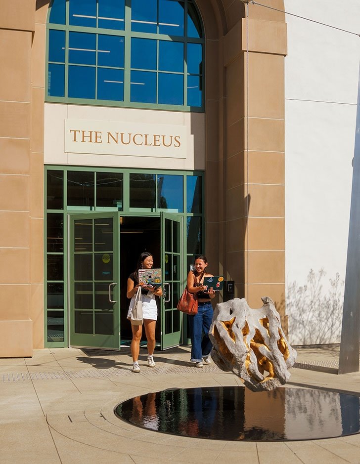 Two students exit the Nucleus