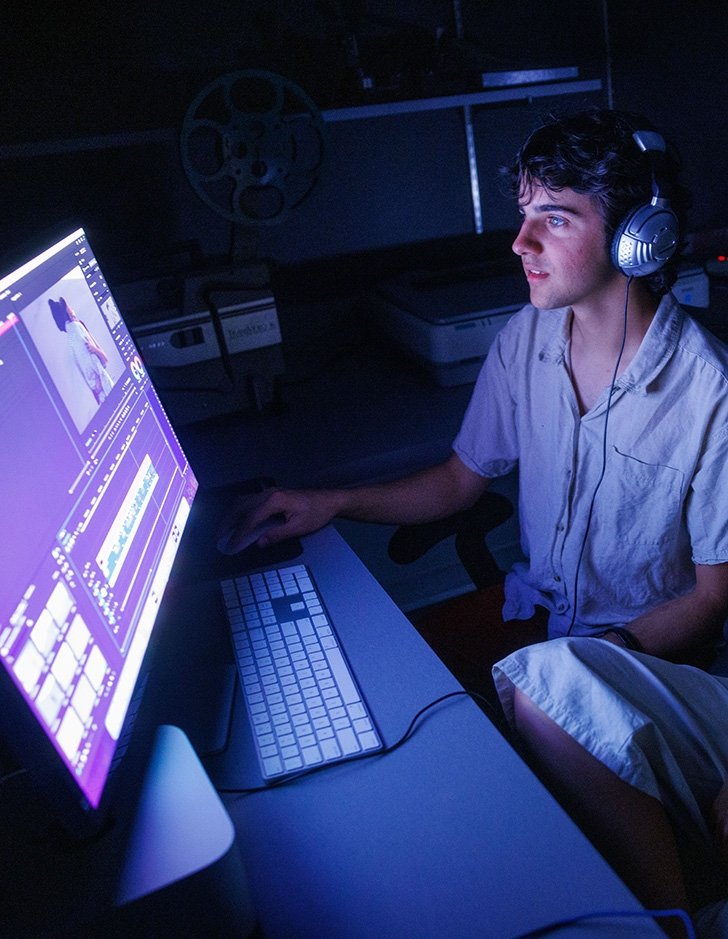 A media studies student works in the editing room