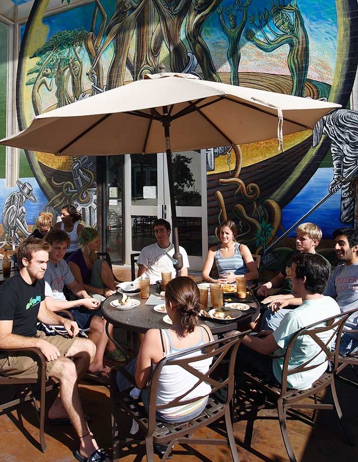 a group of students eat lunch on the outdoor patio of McConnel Dining Hall