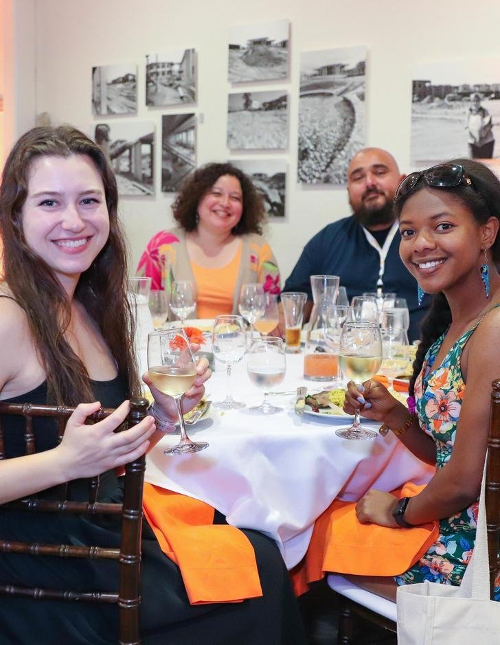 four alumni sit at a table during the alumni awards dinner