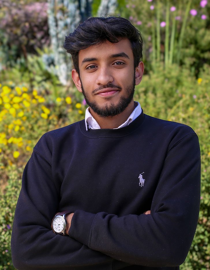 portrait of Isa Iqbal in front of california native landscaping