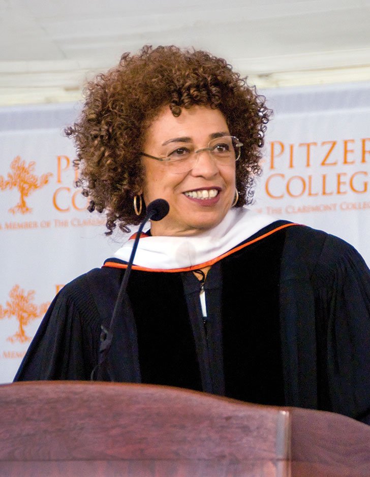 Angela Davis speaks at a podium at Pitzer's commencement ceremony