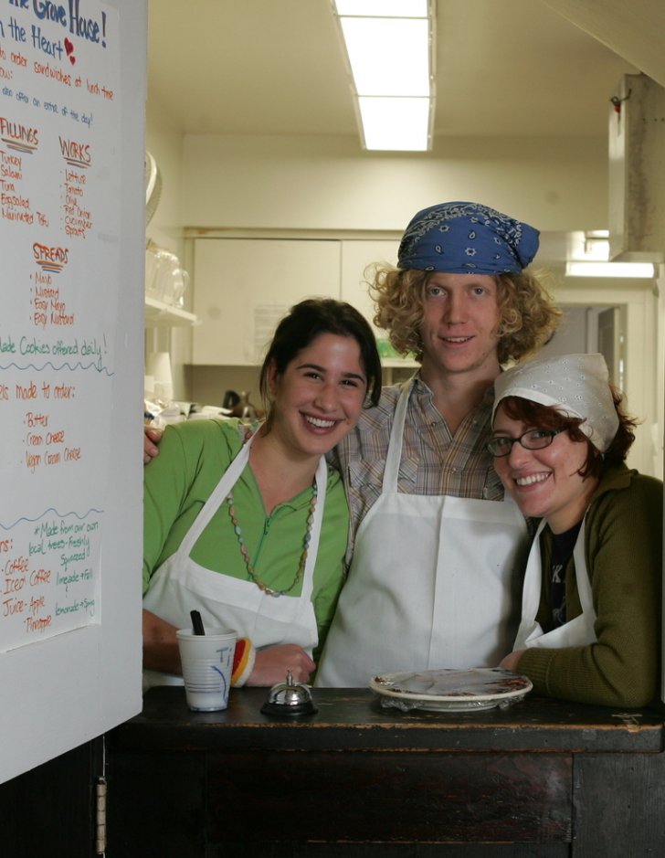 three student workers stand at the ordering door in the Grove House