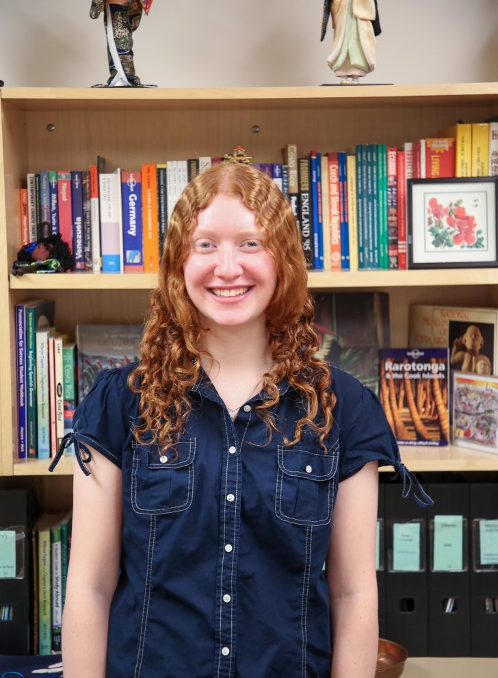 Image of student in front of books