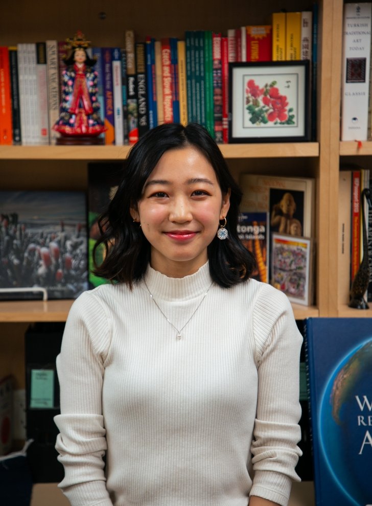 Student in front of books