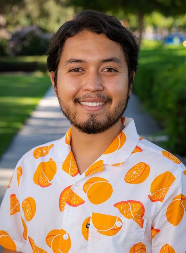 portrait of Diego Tamayo wearing an orange-printed shirt