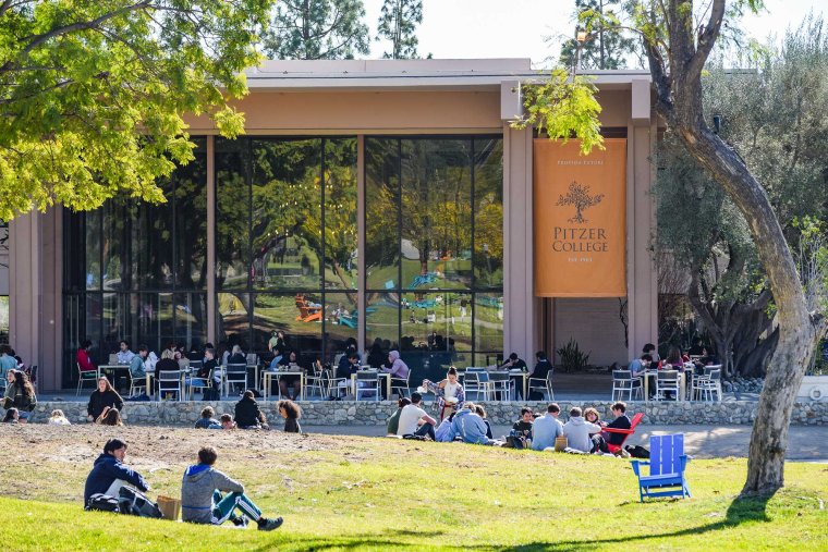 students sit on the mounds in front of McConnell Center