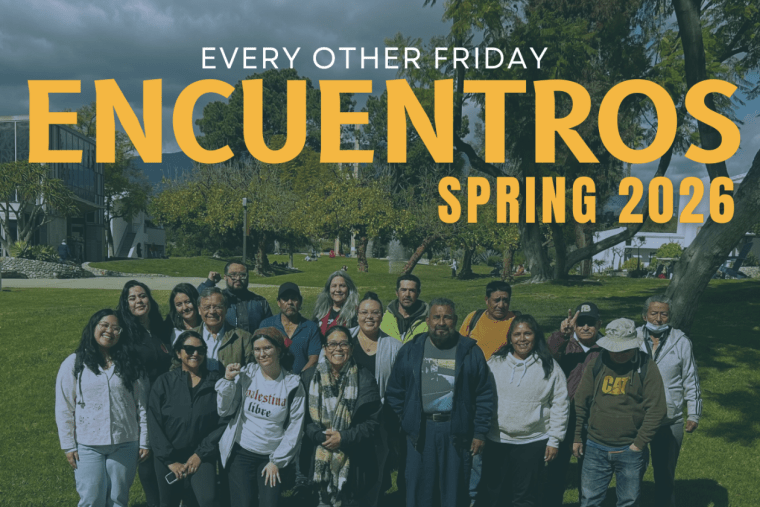 A group of students and community members pose on the the mounds with the words "Every Other Friday Encuentros Spring 2026" above them