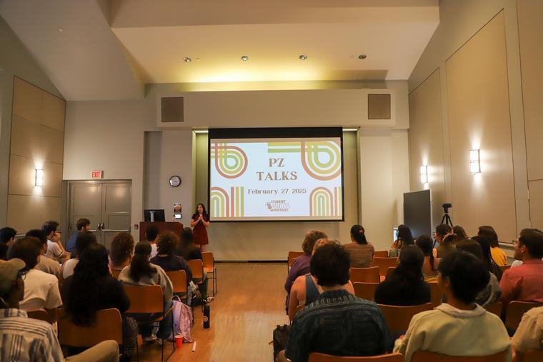 A student giving a talk in front of a crowd in the Broad Performance Center